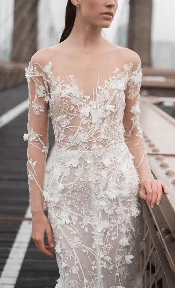 a breathtaking fitting wedding dress in nude and with white floral applique that cover the whole dress, so it seems to be blooming
