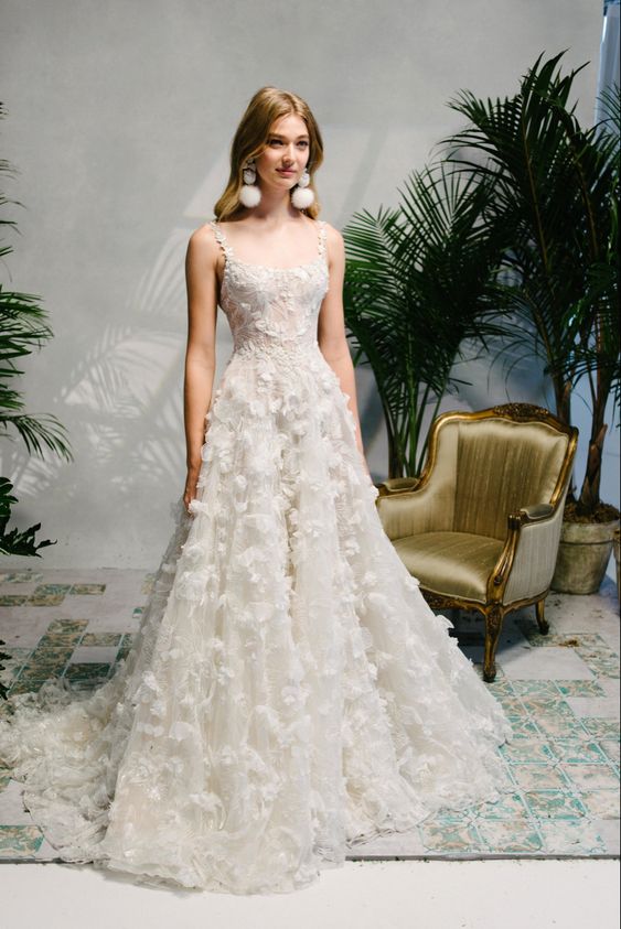 a dreamy wedding dress with floral applique, thin straps and a train plus statement earrings is amazing