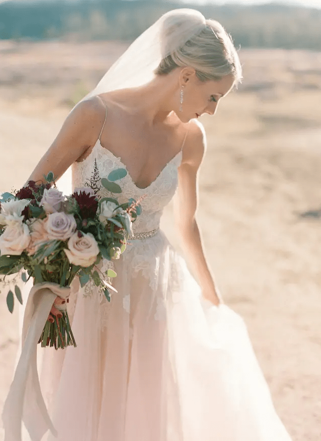 A jaw dropping blush wedding gown with spaghetti straps and white floral appliques by Monique Lhuillier