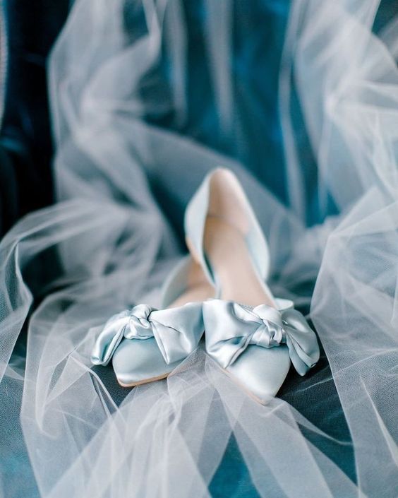 a pastel satin wedding shoes with large bows on tops are amazing for your something blue in the look