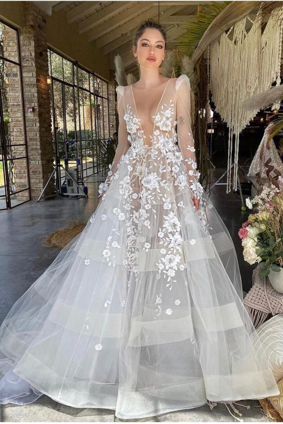 an amazing wedding ballgown with a plunging neckline, floral applique, tiered skirt and illusion sleeves is a wow idea for a wedding
