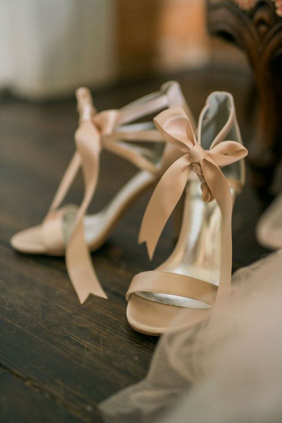 beige wedding shoes with bows on the ankles and high heels are amazing for any spring or summer look