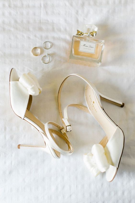 classic white wedding shoes with large bows and ankle straps plus high heels are great for spring and summer weddings