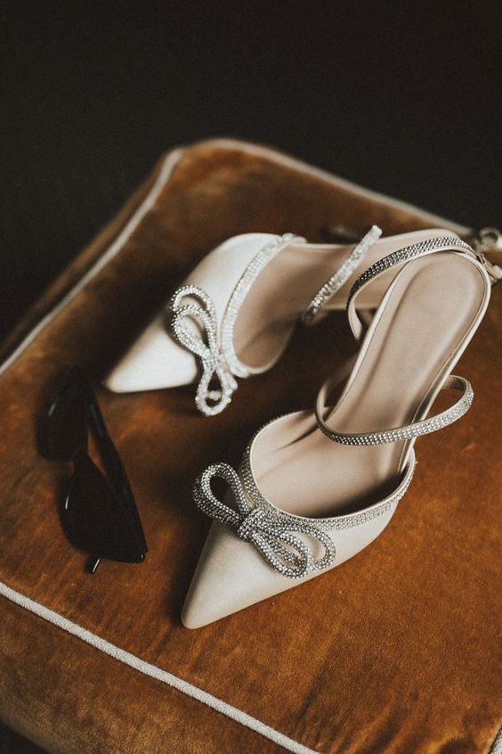 neutral wedding shoes with embellished bows and ankle straps are amazing for any glam bridal look