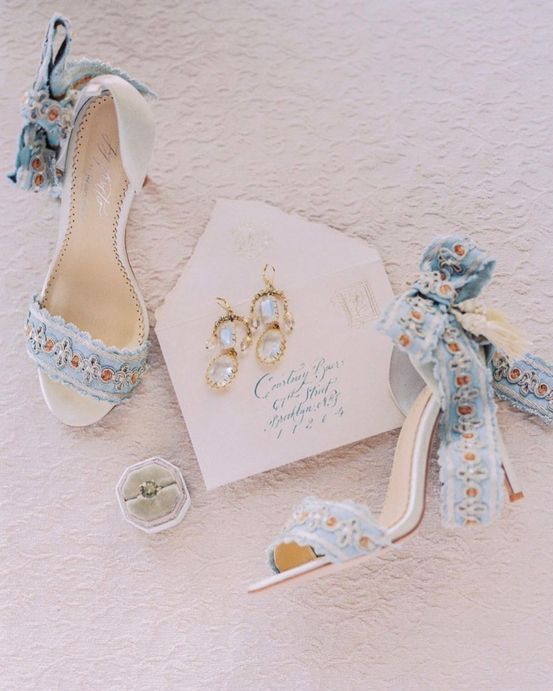 whimsical blue wedding shoes with large blue bows and embellishments are adorable