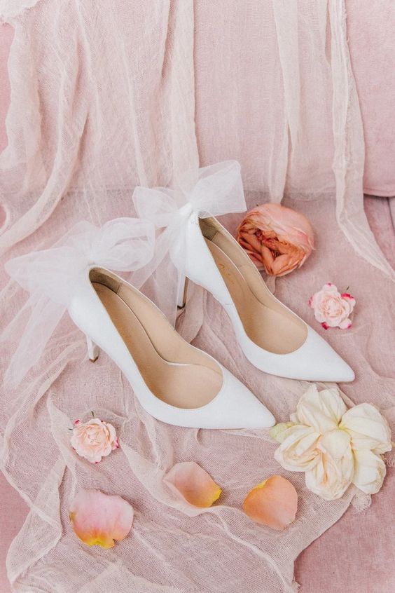 white pointed toe shoes with large bows on the backs, just remove the bows and wear them with any outfit after the wedding