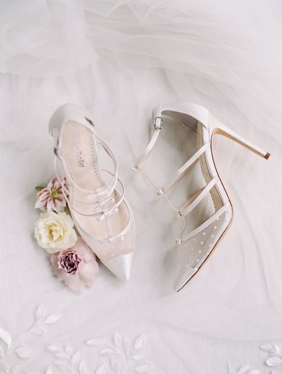 white strappy wedding shoes with little bows and sheer pats plus high heels are a trendy and bold idea