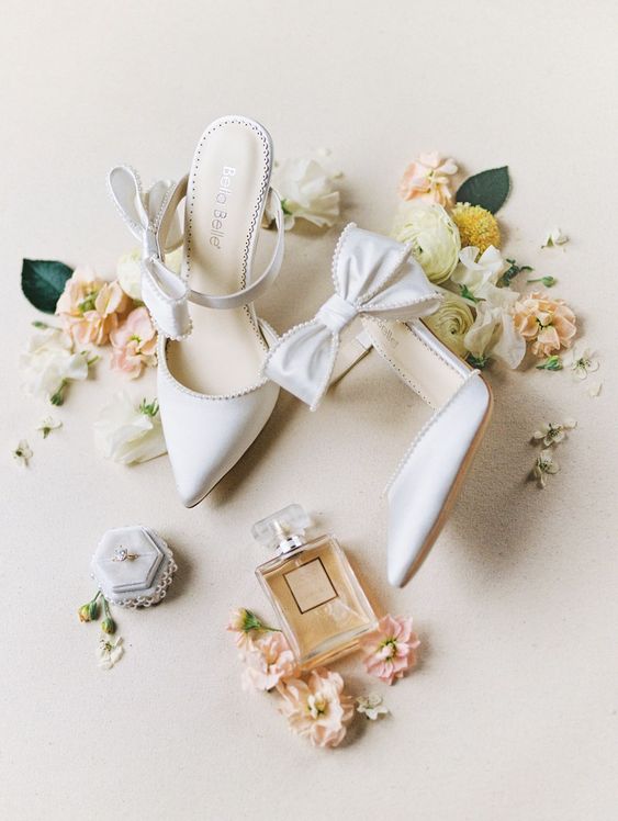 white wedding mules with bows and high heels will be a glam and chic idea for a spring or summer wedding