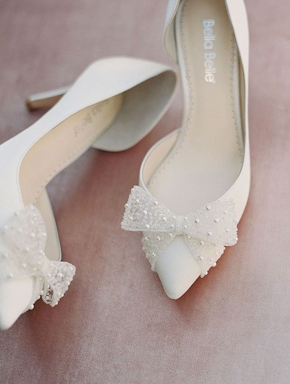 white wedding shoes with embellished bows are bridal classics, they look lovely, catchy and cool