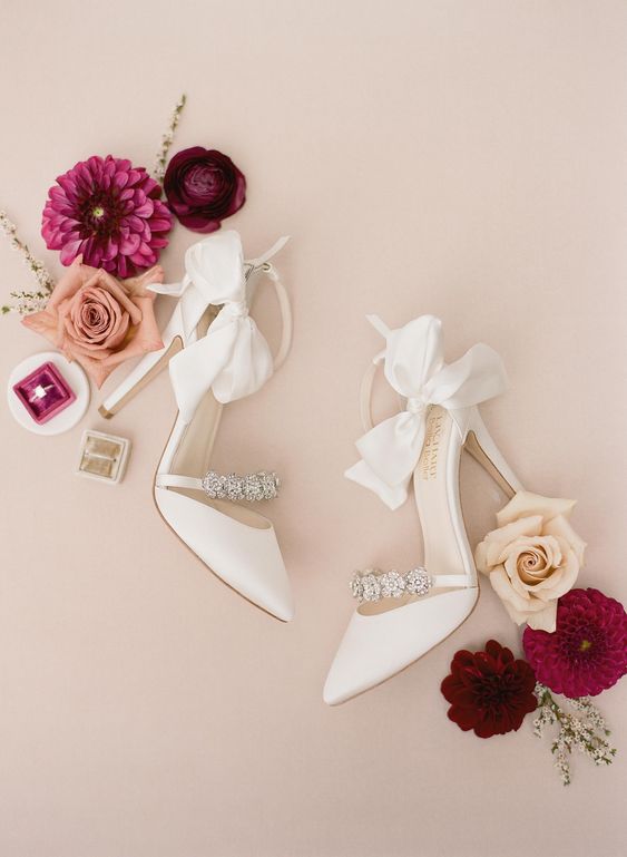 white wedding shoes with embellished straps, high heels and large bows are amazing for a glam wedding