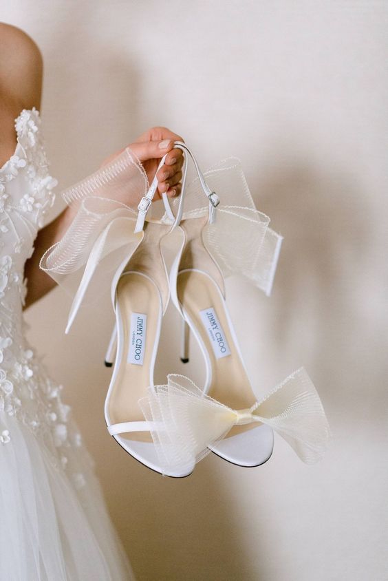 white wedding shoes with oversized tulle bows and high heels are a super feminine idea for a bride