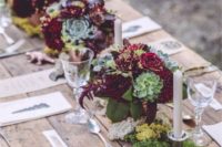02 a rustic table with burgundy flowers and succulents and candles for a rustic shower