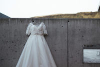 03 The bride was wearing an A-line wedding gown with a lace off the shoulder bodice and half sleeves and a full skirt