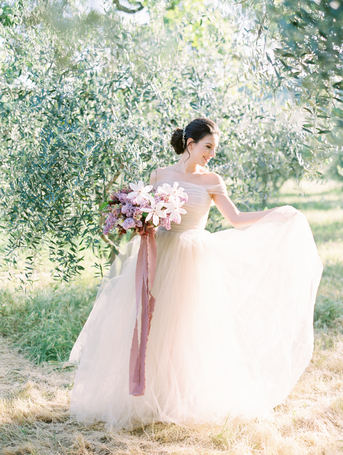 The ethereal off the shoulder blush wedding dress was by BHLDN