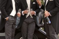 03 groomsmen in black and grey striped morning suits with white roses for buttonholes