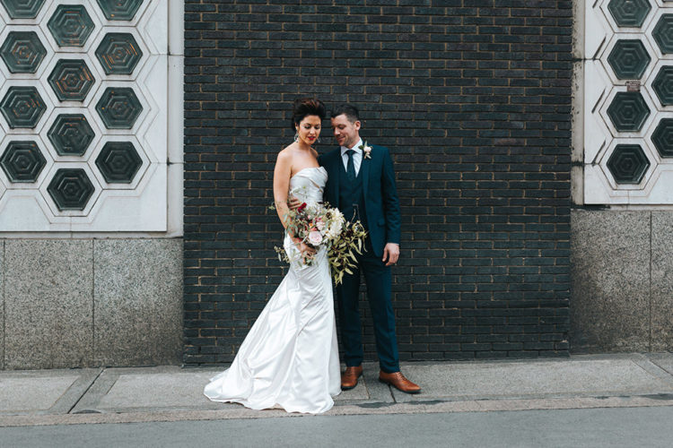 The groom was wearing a three-piece navy blue suit and copper shoes