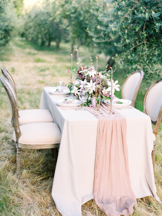 The wedding tablescape was also gentle and romantic, with thin candles and an airy fabric table runner