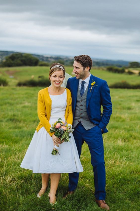 a mustard cardigan and a billy ball boutonniere