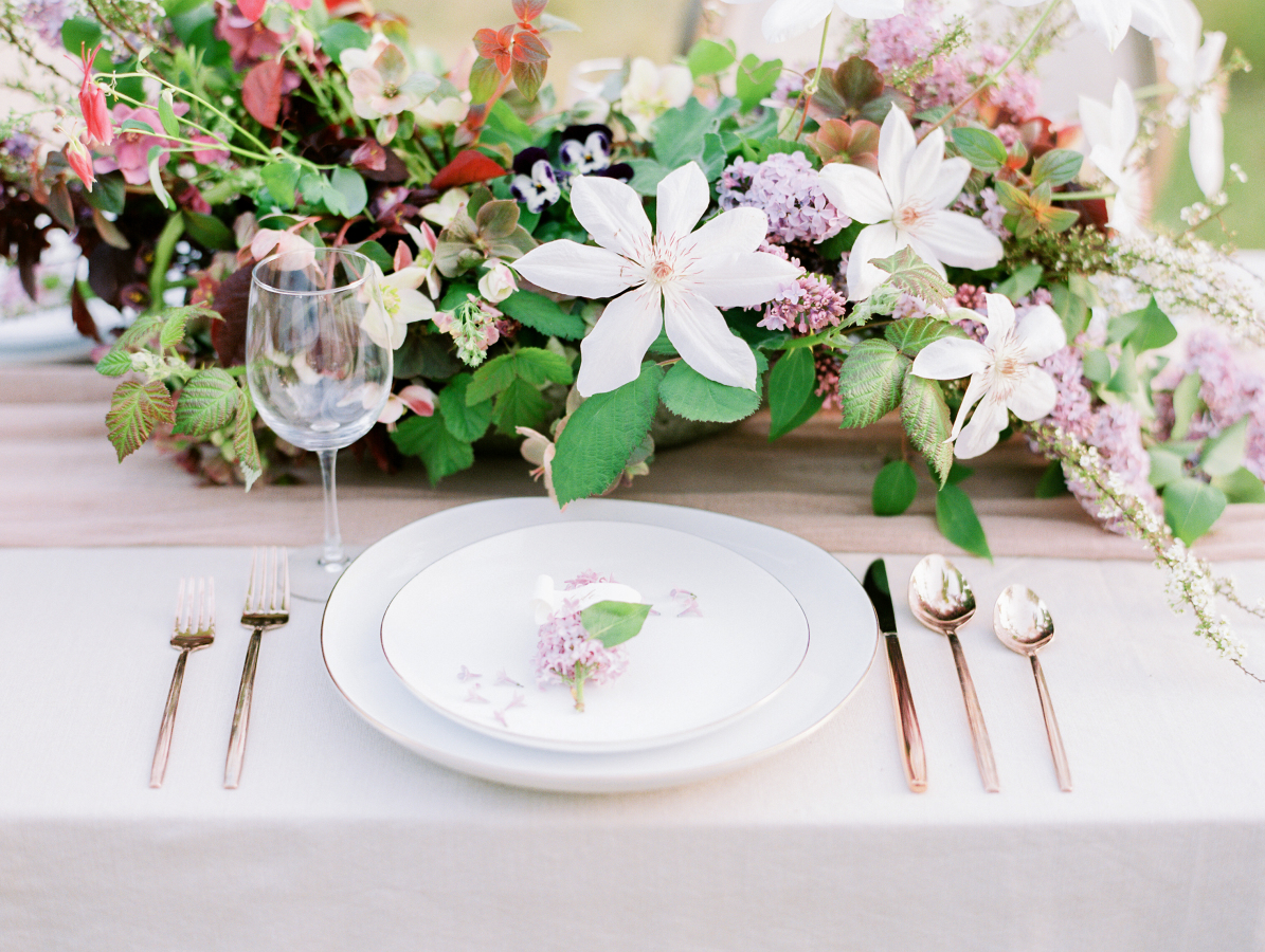 The plates are with a thin gilded edge, and a gorgeous floral centerpiece felt very spring like