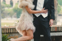 an art deco heavily embellished short wedding dress with a feathered asymmetric skirt, a faux fur cover up and silver shoes create a wow factor