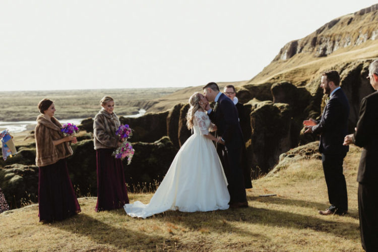 The bridesmaids were wearing purple maxi dresses and brown fur coats, the florals were purple and pink