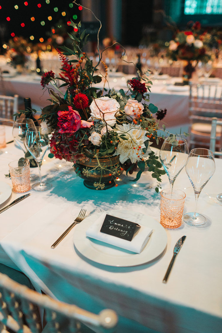 The wedding tablescape was done with bold floral centerpieces, which looked a bit wildflower