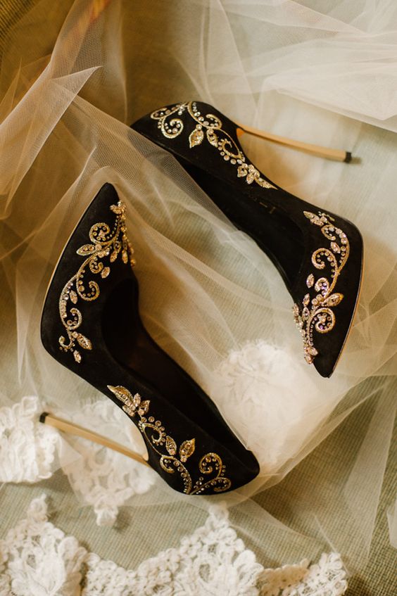black suede stiletto heels with gold detailing and rhinestones