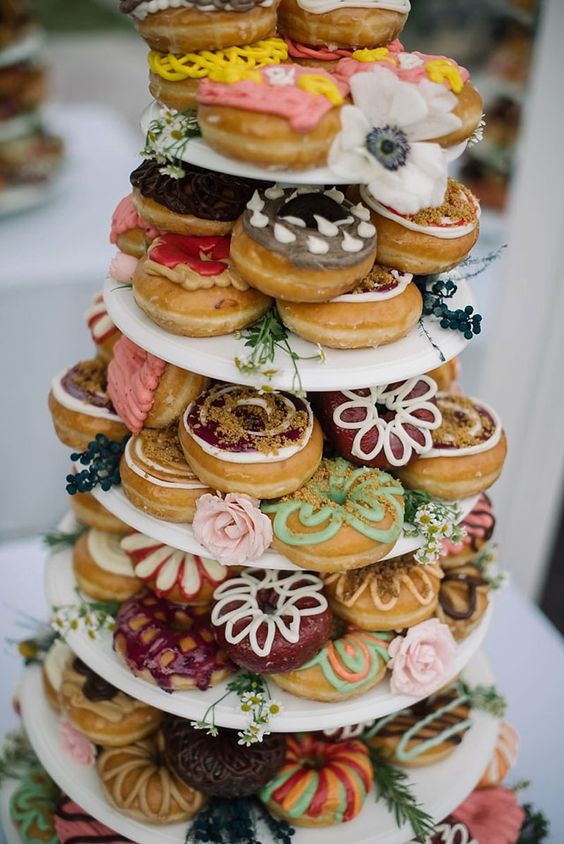 colorful glazed donut tower in boho style for a wedding