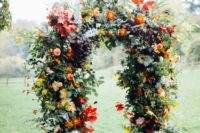 09 lush wedding arch with orange and blush flowers, greenery and red leaves