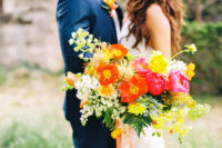 10 The bride was rocking a super bold bouquet in pink, yellow, red and orange
