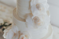 11 All-white wedding cake decorated with roses was a perfect fit for the wedding