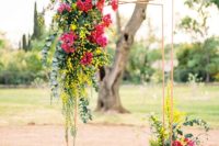 11 I also like the wedding arch with bold yellow and fuchsia flowers on the corner