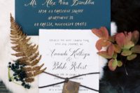 11 a blue envelope with gold calligraphy and an invite with blue watercolor touches and an antler tag
