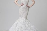 a strapless sweetheart neckline lace and heavily embellished mermaid wedding dress with a feather skirt is a stunning idea for a glam bride