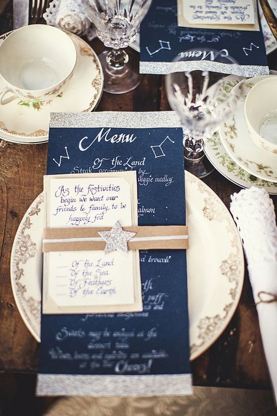 a navy and silver glitter menu and a star topper