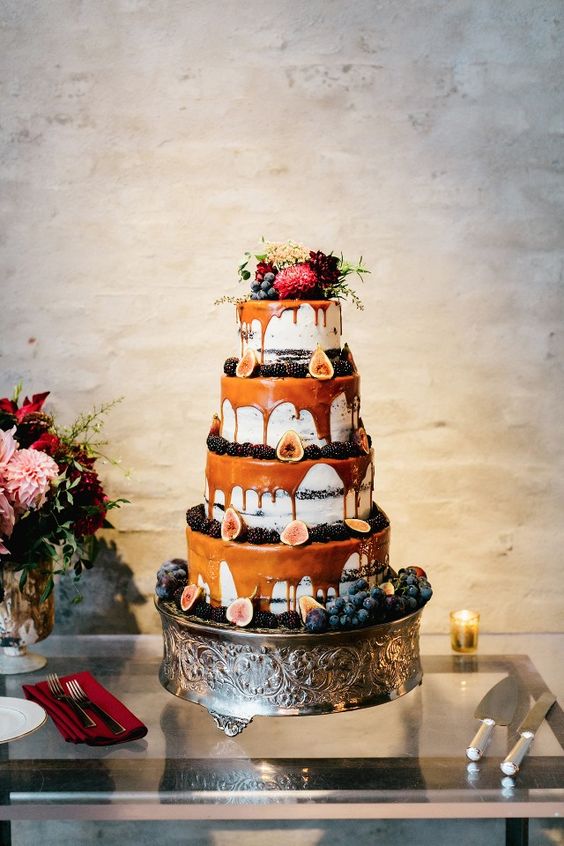 multi-layer drizzle wedding cake with caramel drip, blackberries, figs and topped with fresh blooms