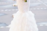 a strapless sweetheart neckline mermaid wedding dress with embellishments and a feather skirt is a perfect glam solution for a fashion-forward bride