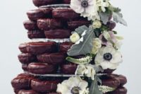 14 chocolate glaze donut tower with greenery and fresh blooms