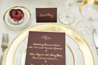 15 a gold charger and flatware, gilded edge plates and glasses, cards and menus with gold calligraphy