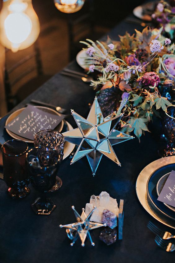 dark florals and 3D shaped star decorations for a starry table setting