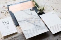 16 marble wedding invitations in black and orange envelopes