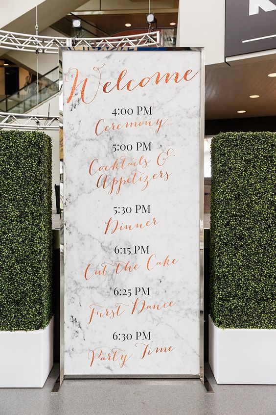 oversized marble wedding program with copper calligraphy