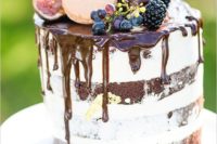 18 chocolate cake with chocolate drip, topped with grapes, blackberries, figs, macarons