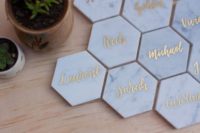 18 marble place cards with gold calligraphy in hexagon shape
