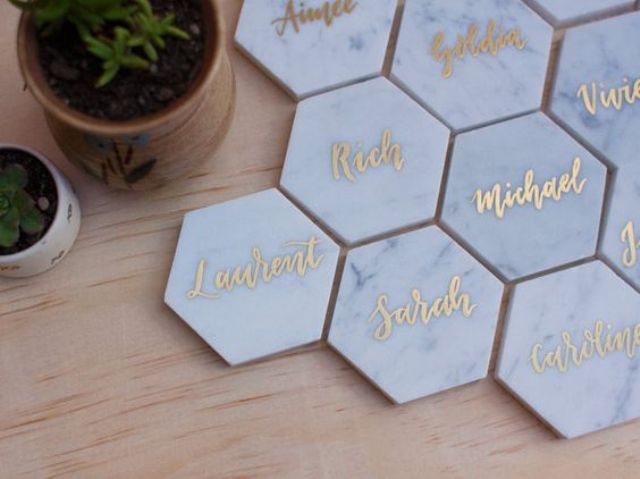 marble place cards with gold calligraphy in hexagon shape