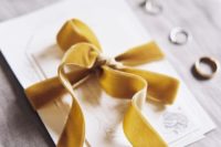 18 mustard-colored velvet ribbon tied invitation suite
