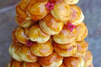 19 a caramel topped croquembouche with small fresh flowers