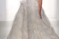 a sleeveless beaded halter neckline wedding ballgown with a feather skirt with a train is a very sophisticated and glam idea