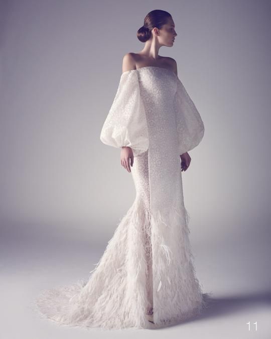 off the shoulder wedding dress with bell sleeves and a feathered skirt for a winter bride
