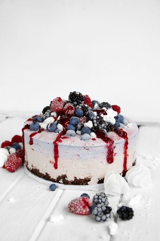 strawberry black currant ice cream cake topped with blueberries, blackberries, raspberries